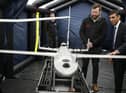 Prime Minister Rishi Sunak speaks with staff as he views a drone used for surveillance of vessels in distress, during a visit to the Home Office joint control centre in Dover