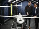 Prime Minister Rishi Sunak speaks with staff as he views a drone used for surveillance of vessels in distress, during a visit to the Home Office joint control centre in Dover