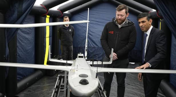 Prime Minister Rishi Sunak speaks with staff as he views a drone used for surveillance of vessels in distress, during a visit to the Home Office joint control centre in Dover