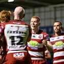 Zach Eckersley (centre) celebrates a try with his Wigan Warriors teammates