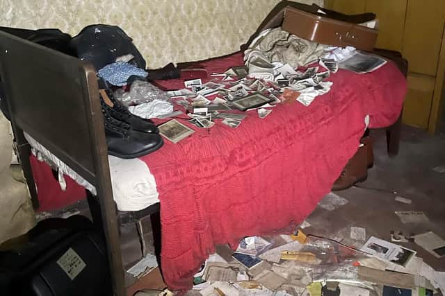 A bed littered with photographs