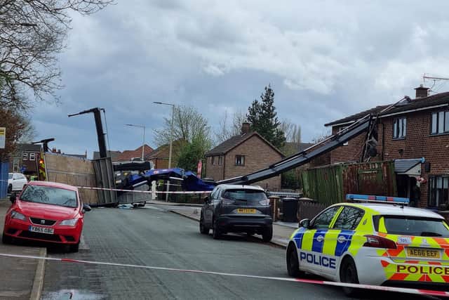 A lorry carrying a crane has overturned and crashed into a house on Flapper Fold Lane, Atherton. Picture by Nigel Peacock