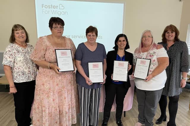 Foster carers with 20 years service recognition award.