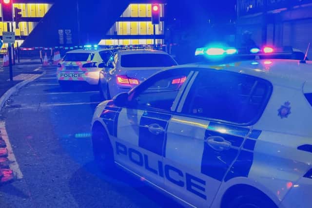 TheG suspect car sandwiched between two patrol cars on Caroline Street, Wigan
