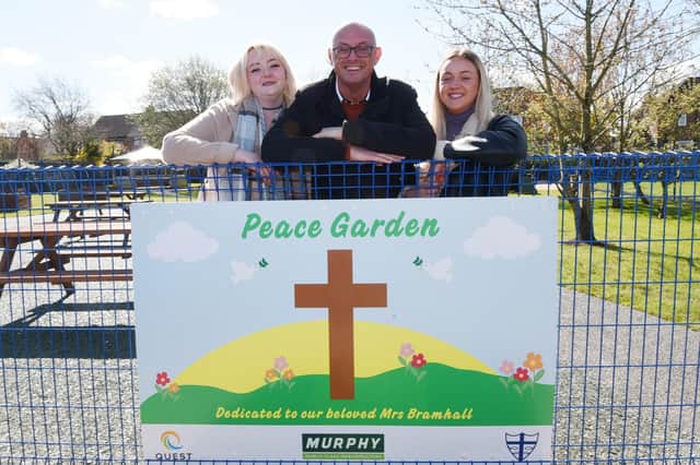 Carl Bramhall, centre, with daughters Kammalah, left, and Tegan, right, the husband and daughters of the late Julie Bramhall at the Peace Garden official opening.