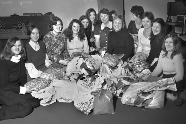Workers at Wigan telephone exchange gather parcels to distribute to local pensioners for Christmas in 1973.