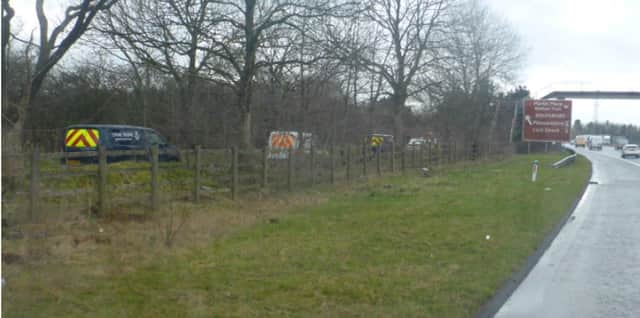 Police at the scene where Christopher Hughes's body was found near to the M58 at Skelmersdale