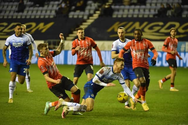 Latics were denied a penalty in the second half for this challenge on Tom Naylor