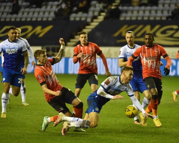 Latics were denied a penalty in the second half for this challenge on Tom Naylor