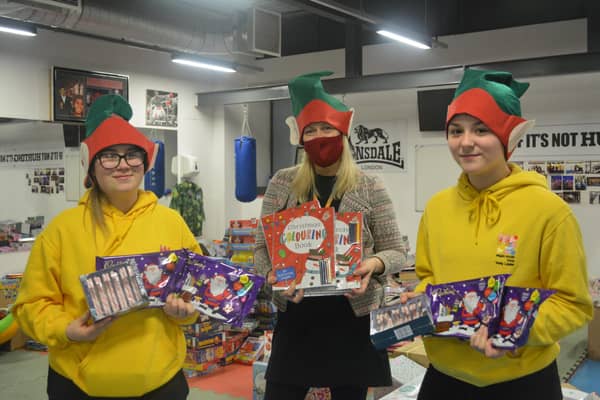 Staff and volunteers with Christmas treats for hampers