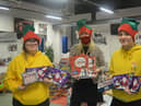 Staff and volunteers with Christmas treats for hampers