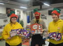 Staff and volunteers with Christmas treats for hampers
