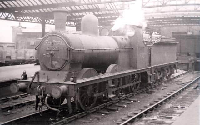Acting Pilot Loco No 65159 stands between the Liverpool direction bays at the south end of Wigan Central station in 1956. The smokebox door bears the inscription 'Just married to Wigan bank engine' in chalk, whilst below the front number plate is scrawled 'The Dragon.' There were often lengthy periods of inactivity for these engines and the words were probably scribed on by a Springs Branch firemen with little else to do! (Author's Collection).