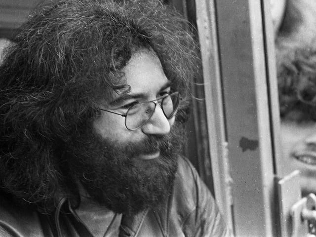 Lead guitarist for American rock band the "Grateful Dead" Jerry Garcia, chats to fans backstage after the group's marathon session at Bickershaw Festival in 1972.