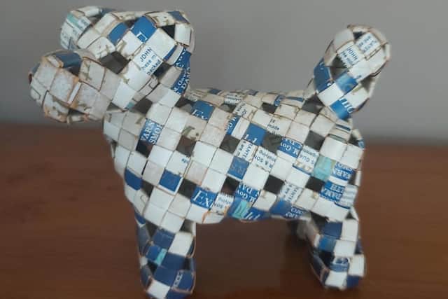 A photo of the dog made out of cigarette boxes