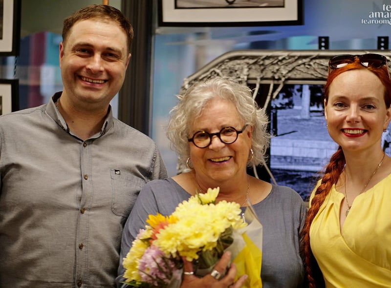 Tea Amantes owners Anna Margaret Paprzycka and Przemek Malachowski, present a bunch of flowers to Dawn Mander as her work goes on display at the Blackpool tea rooms.