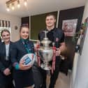 Jacob Douglas and Ethan Havard from Wigan Warriors with Sales Advisors Amelia Suffell and Kayleigh Jones with the challenge cup.