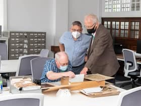 Michael Caine an Archives: Wigan and Leigh visitor engagement volunteer exploring archive collections with local dignitaries at the opening celebration.