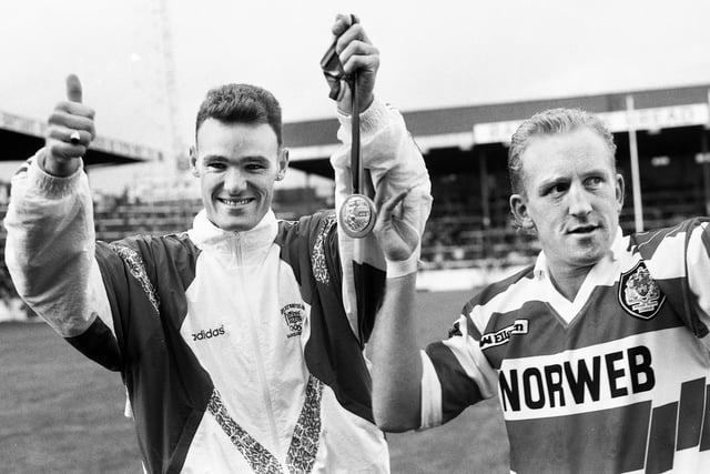 Wigan athlete David Grindley shows his Olympic bronze medal to the crowd at Central Park for Shaun Edward's testimonial match on Wednesday 12th of August 1992.
David was part of the British 4x400 metres relay team which came third at the Barcelona Olympics that year.