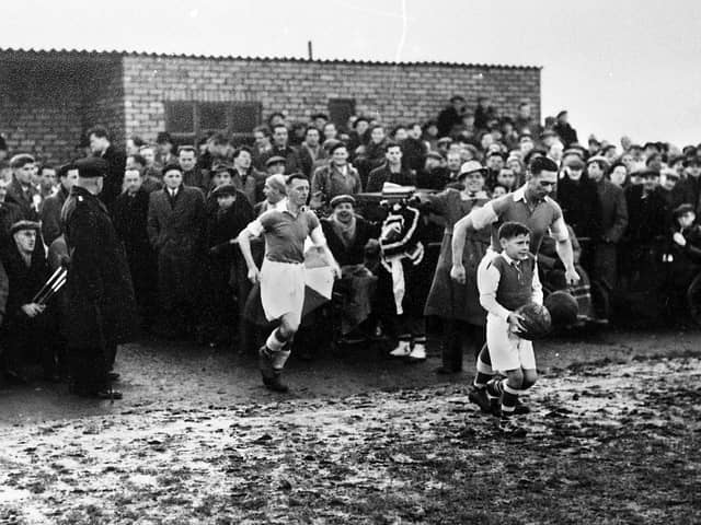 Wigan Athletic captain Dave Mycock leads the team out at Springfield Park for the FA Cup 3rd round replay against Newcastle United on Wednesday 13th of January 1954.
Lancashire Combination side Latics had drawn the first match 2-2 at St. James Park on the previous Saturday against the "Magpies" who were at the height of their glory years with a team that included legends such as Jackie Milburn, Jimmy Scoular and Ivor Broadis.
Despite two goals from centre forward Billy Lomax Latics lost 2-3 but not without a great fight.