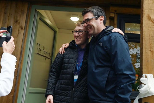 Mayor of Greater Manchester Andy Burnham poses for photos during his visit.