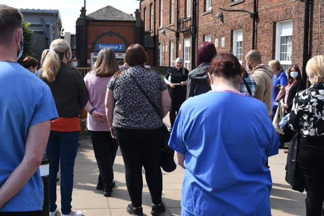 Family, friends and colleagues attend a remembrance ceremony and plaque dedications at the Roy Hartley Memorial Garden, within the grounds of Wigan hospital,  in memory of midwife Linda Clarke who had died of coronavirus a year before