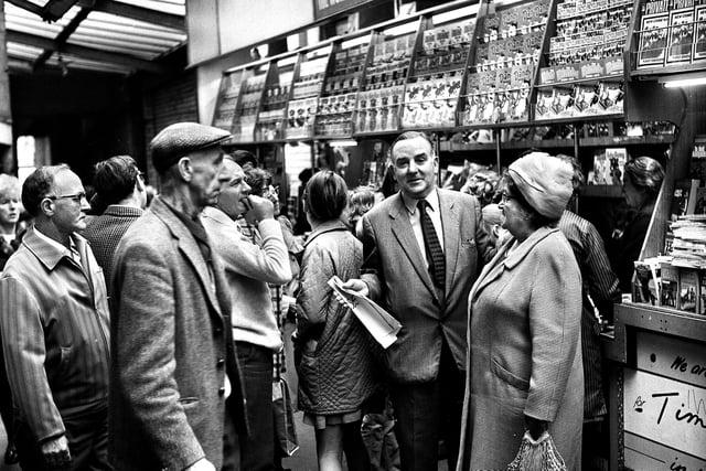 Sid Smith at his busy newspaper stall in the Market Arcade, better known as the Little Arcade, Wigan in September 1971. 
