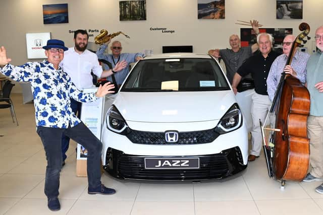 From left, Band member pianist Paul Kilvington, Honda sales manager Richard Davies, saxophonist Al Wood, drummer Dave Hassell, Ian Darrington co-organiser of Wigan Jazz Festival, bassist Dave Lynane and Wigan Jazz Festival co-organiser Peter Fletcher, next to a Honda Jazz car.