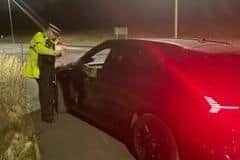 A police officer speaks to a driver on Westwood Way