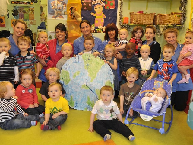 Staff and children at Parsons Walk Nursery, Wigan with their giant home made clock in 2010