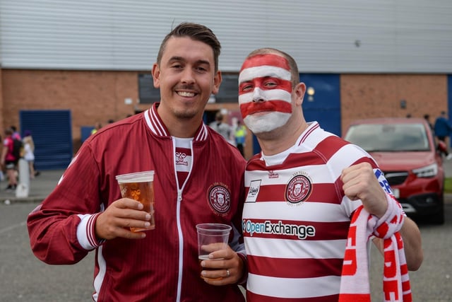 One fan shows off his cherry and white face paint.