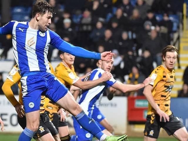 Callum Lang forces home a late goal at Cambridge back in November