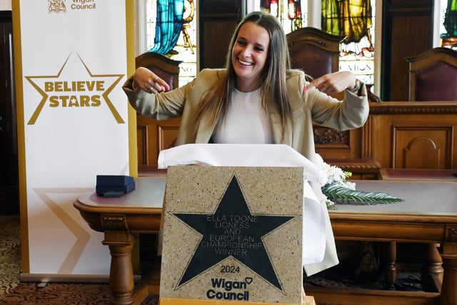 Football champion Ella Toone, Lioness and European Championship Winner, with her star, placed outside Leigh Town Hall.
