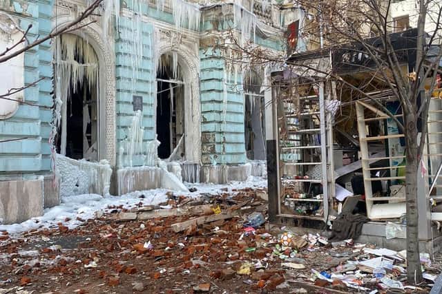 Windows blown out from bombings and rubble covering the streets.
