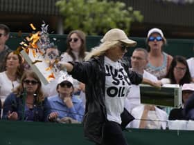 A Just Stop Oil protester runs onto Court 18 and releases confetti