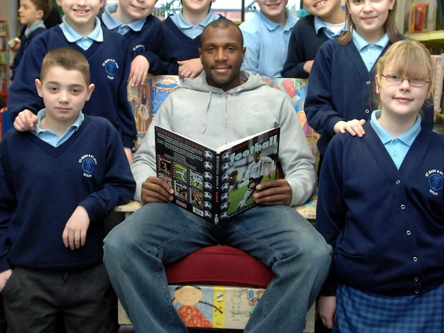 Wigan Athletic defender Emmerson Boyce visited the temporary Children's Library at The Galleries, Wigan to read stories to youngsters and play Wii. Pictured with him are, left to right: Jack, Tom, James, Edward, Daniel, Ashley, Helen and Beth.