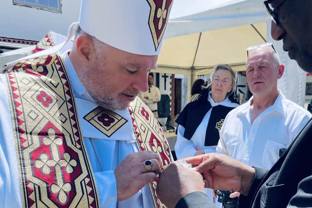 Archbishop Steven Evans receives his knighthood from Archbishop Doyé Agama