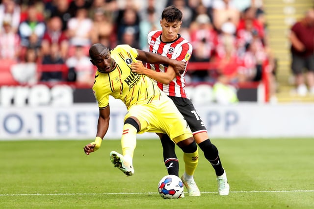 SHEFFIELD, ENGLAND - AUGUST 06: Benik Afobe of Millwall is challenged by Anel Ahmedhodzic of Sheffield United during the Sky Bet Championship match between Sheffield United and Millwall at Bramall Lane on August 06, 2022 in Sheffield, England. (Photo by Cameron Smith/Getty Images)