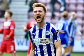 Callum McManaman - Latics' star man throughout - celebrates Jason Kerr's late winner with the East Stand