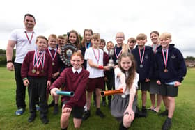 Sports co-ordinator Mr Carr and headteacher Mrs Gough with pupils from Year four, five and six, at Wood Fold Primary School.