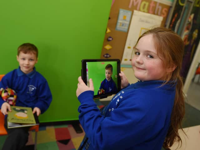 Pupils are working with green screen technology in the classroom.