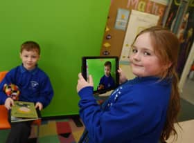 Pupils are working with green screen technology in the classroom.
