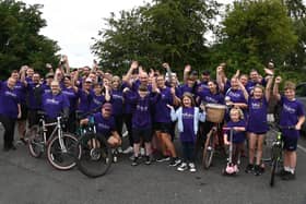 Olly Johnson, centre, cheers on the cyclists as they set off for last year's ride