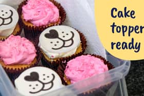 An image of Guide Dogs' dog face cake toppers on cupcakes.