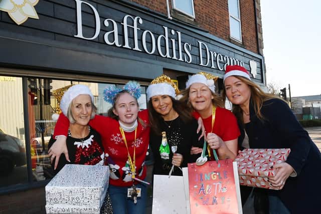 Noreen Bond, Katie Wilkes, Joanne Bimson, Maureen Holcroft and Shelley Brady are still collecting donations at Daffodils Dreams' boutique on Wallgate, Wigan