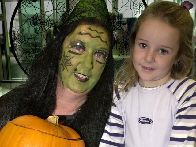 Wigan Asda staff donned Halloween costumes to entertain children and hand out free sweets. Pictured is Sarah Willmoth the friendly witch with young customer Hannah Barker