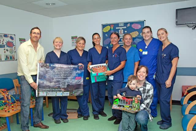 Dominique, far left, Sarah and Harry, front right thanking the staff at Wigan Infirmary's Rainbow Ward