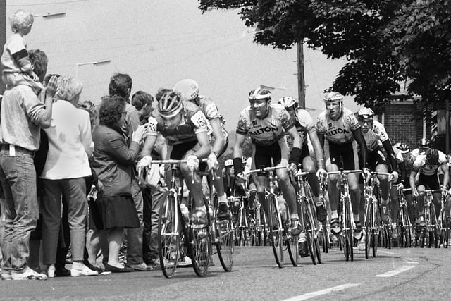 Throngs of people applaud the Tour of Britain Milk Race as it passes Rogersons bike shop at Orrell Post on a stage of the top cycling event on Sunday 3rd of June 1989.