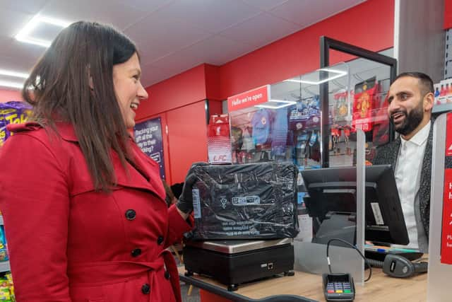 Wigan MP Lisa Nandy at the new post office with postmaster Arif Matadar