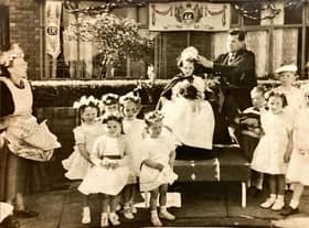 A young Elaine is crowned queen for the day during the 1953 coronation celebrations in Beech Hill. Doing the crowning is rugby legend Joe Egan